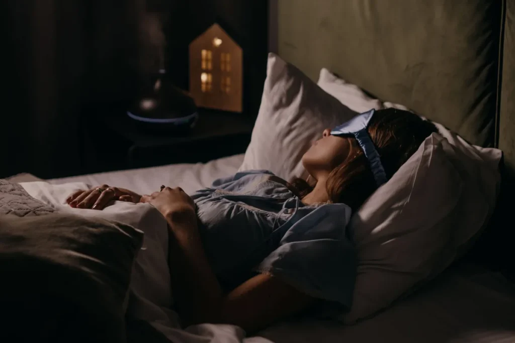 Personne endormie paisiblement dans un lit confortable la nuit, symbolisant le repos et l'hygiène intime.
