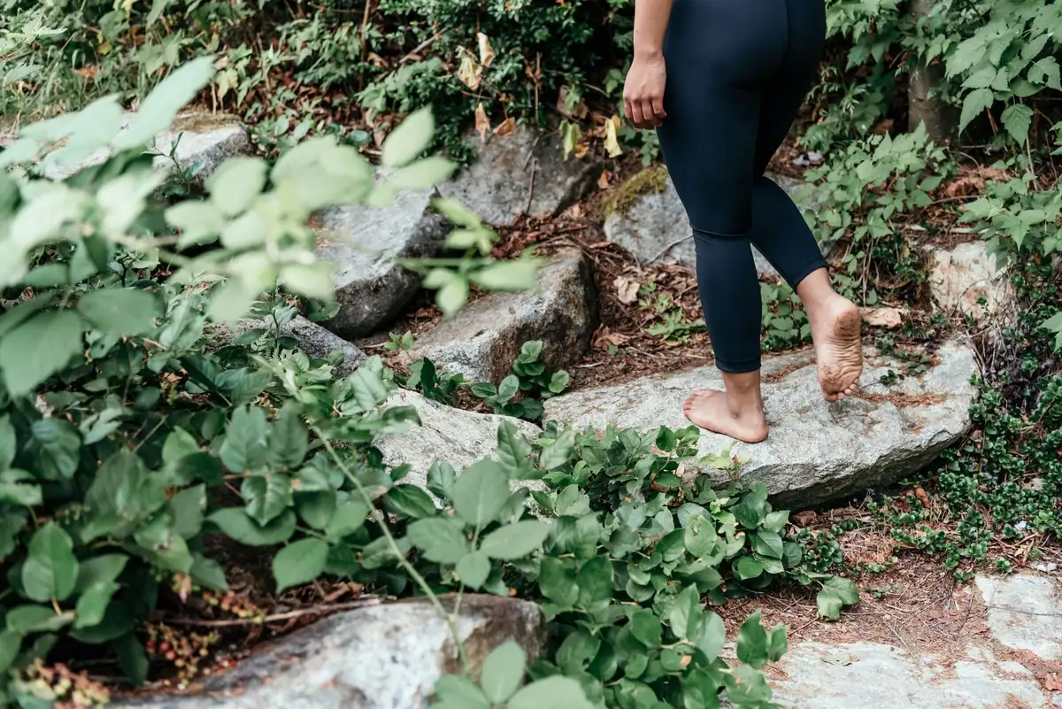 Personne marchant lentement en forêt, en pratique de pleine conscience et d'observation