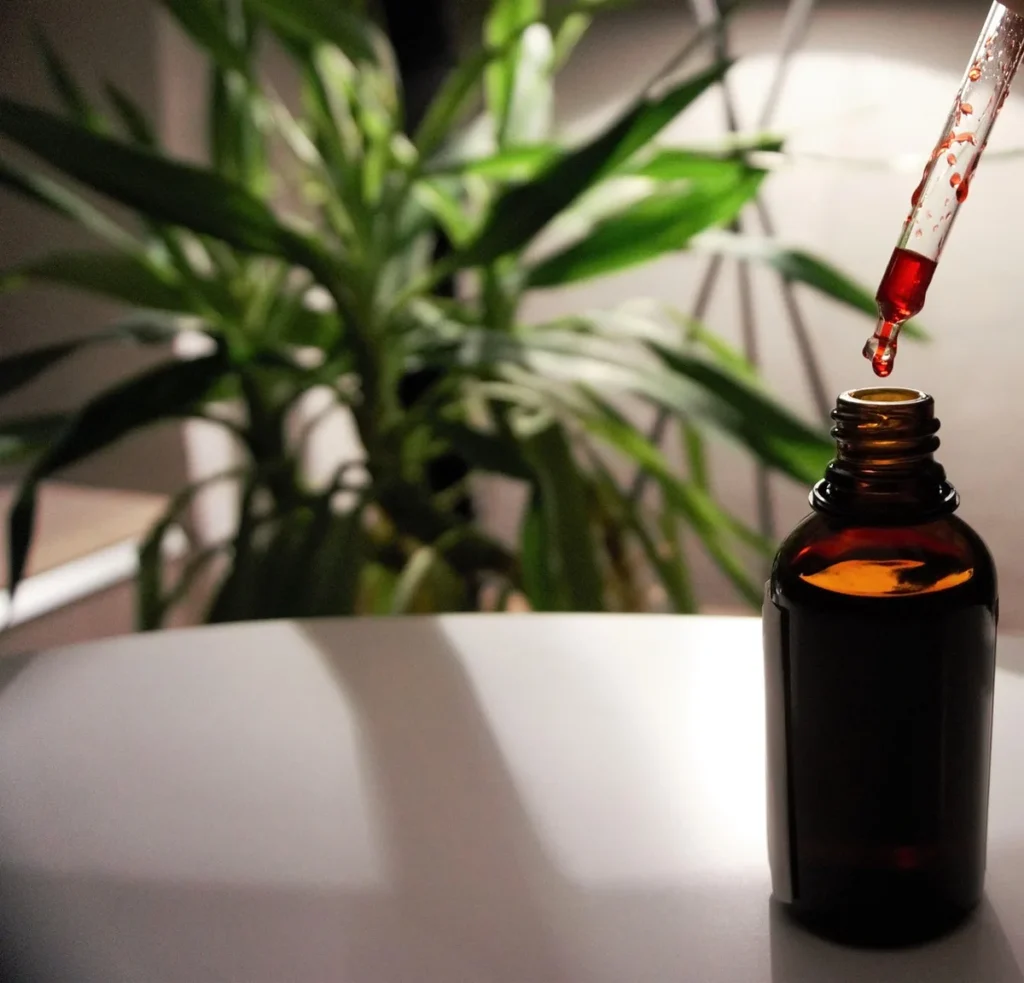 Flacon de sérum avec pipette posé sur une coiffeuse en lumière du jour